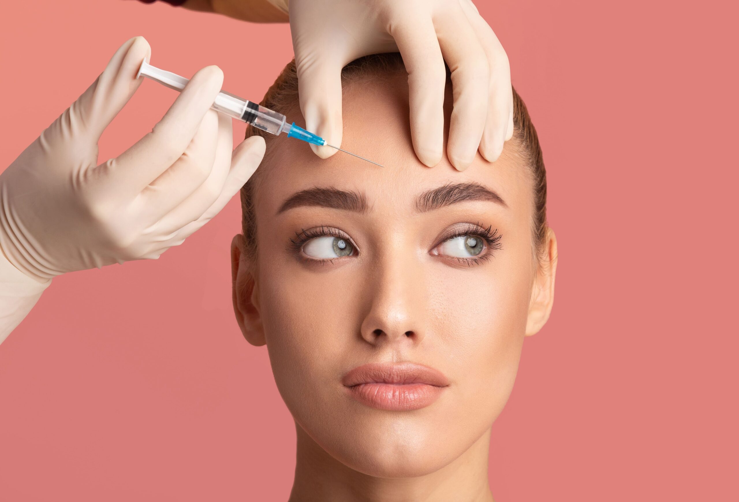 women getting botox injected in her forehead